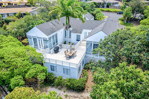 Stunning aerial perspective highlights inviting balcony and picturesque surroundings around the beautiful home