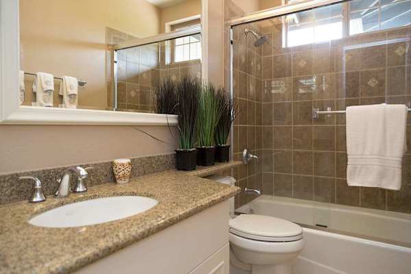 Guest Bath featuring Granite Vanity & Tub/Shower Combination