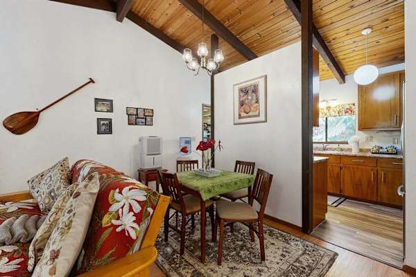 Compact Dining Corner with Wooden Table, Overhead Light & Kitchen Vie