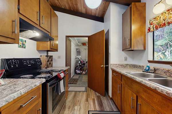 Alternate Kitchen View Highlighting Double Sink, Electric Range & Pantry Door