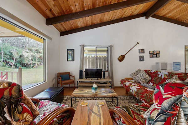 Living Room View Highlighting Floral Sofas, Coffee Table & Large Picture Window