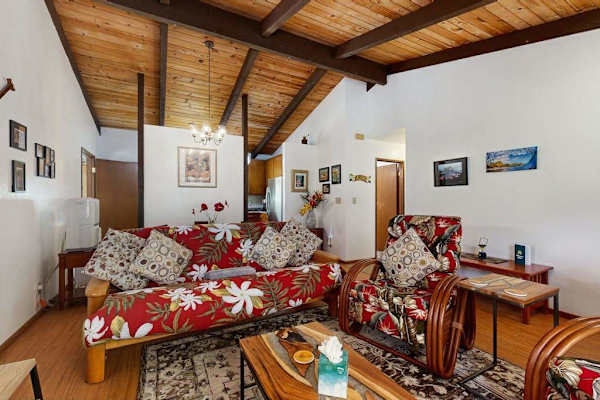 Open Living Space with Vaulted Beamed Ceiling & Floral Print Seating