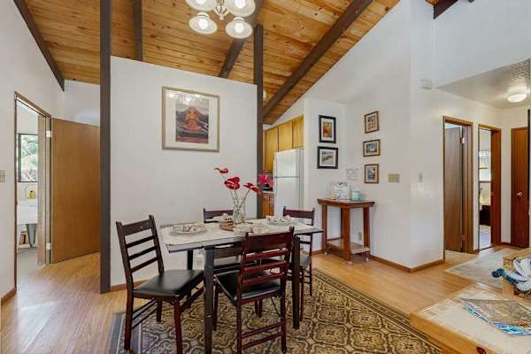Open Dining Area with Wooden Table Set and View to Kitchen & Hallway