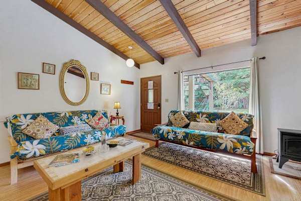 Cozy Living Room Featuring Matching Tropical Sofas & Decorative Wall Mirror