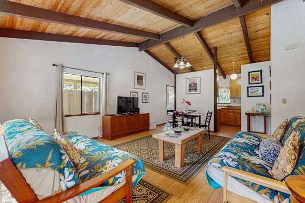 Bright Open Layout Showing Living Room, TV Console & Adjacent Dining Area