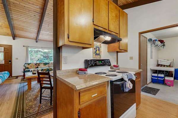 Kitchen Corner View Showing Electric Stove with Pass-Through to Living Area