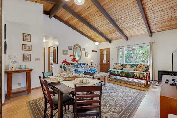 Open-Concept Dining & Living Area Under Vaulted Ceilings with Exposed Beams