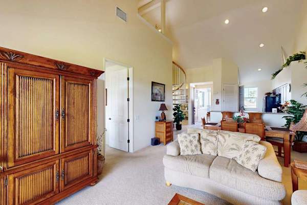 Open-Concept Living Area with Large Armoire & High Ceilings