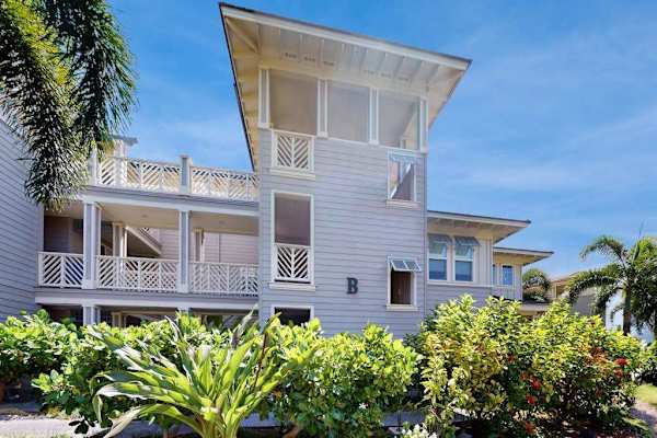 Property Exterior View with Covered Balconies & Palm Trees