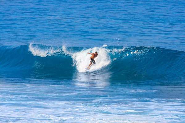 Popular surf spot near Kailua-Kona, a highlight for visiting surfers.