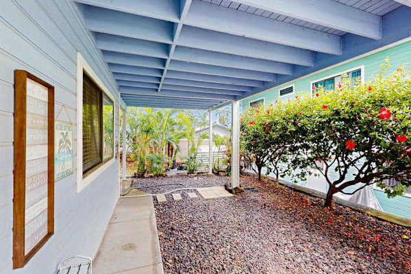 Beautiful covered patio walkway featuring a vibrant blue pergola, manicured garden hedges, and a peaceful outdoor vibe! 🌿✨