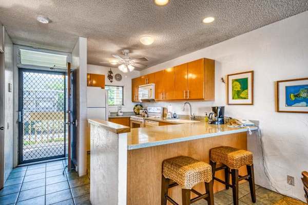 Functional kitchen area featuring a breakfast bar with barstools and plenty of counter space