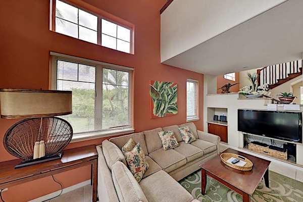 Living room with flat screen tv, high ceilings and plenty of natural light.