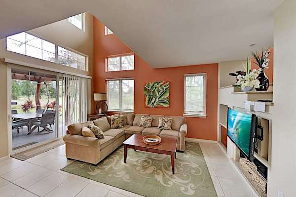 Comfortable living room with sofa bed for extra company, flat screen tv and lanai access.