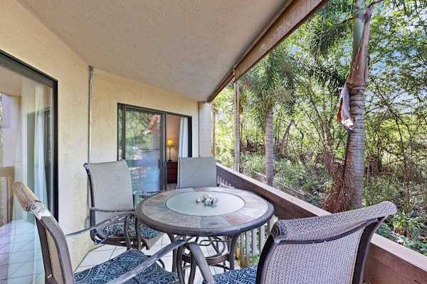 Private balcony with dinning table overlooking the lush greenery 