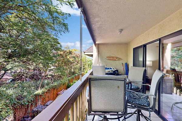 Private balcony with dinning table overlooking the lush greenery 