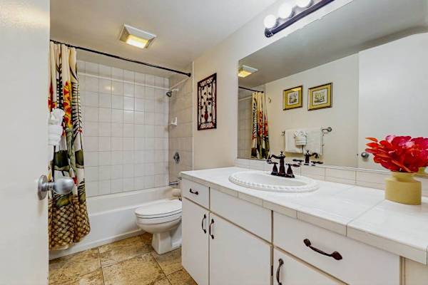 Bright guest bathroom with ample counter space.