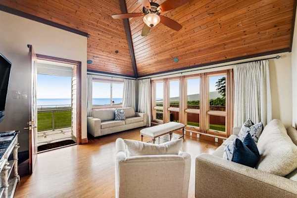 Open-Concept Living Area with Direct Patio Access & Ceiling Fan