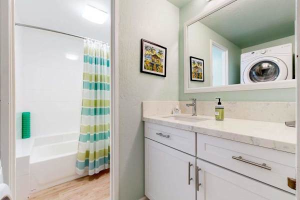 Full Bathroom With Tub And Laundry Convenience