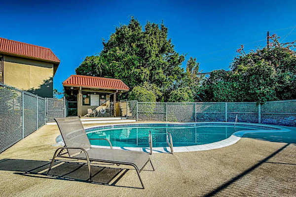 Poolside Lounge Deck with Outdoor Swimming Pool and Fenced Enclosure