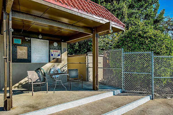 Backyard Covered Pavilion with Patio Seating and Information Board