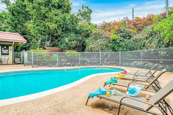 Outdoor Swimming Pool with Lounge Chairs and Fenced Deck