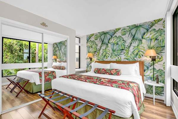 Primary Bedroom with Mirrored Closets & Lush Tropical Decor