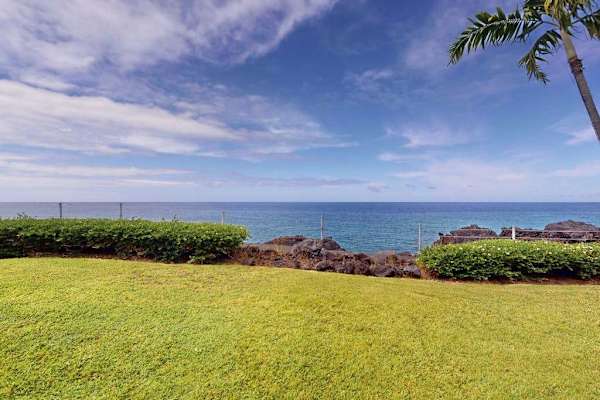 Expansive Ocean View Across Manicured Resort Lawn and Coastal Hedges