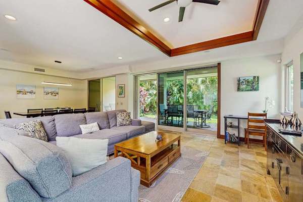 Living Room with plenty of seating with this comfortable sectional and open to the dining room and kitchen in this open floor plan design.  Lots of naturals light from the windows and sliding doors.