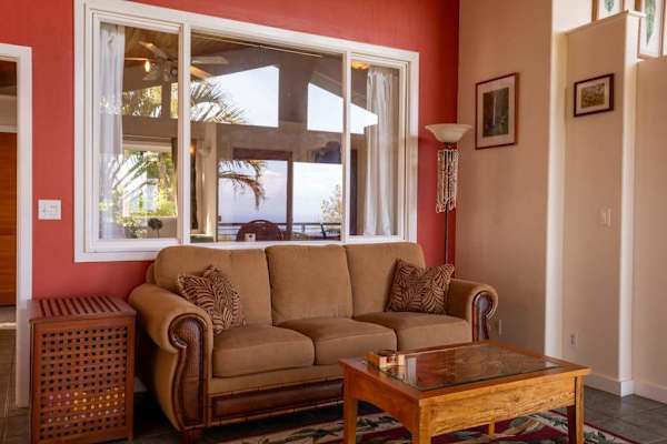 Cozy Living Area with Plush Sofa, Warm Accent Wall & Natural Light