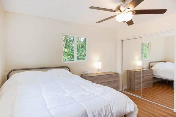 Guest room with double bed and a ceiling fan.