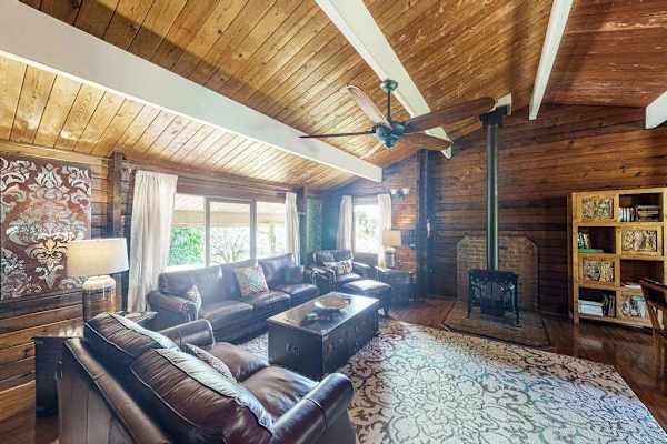 This home has an open-concept indoor living design with modern furnishings, vaulted ceilings, and even a gas fireplace for warming up on those high-elevation cool and damp volcano evenings.