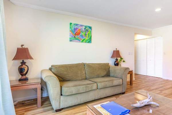 Cozy Living Room Seating Area with Comfortable Sofa, Accent Lighting, and Coffee Table