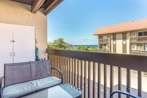 Private Balcony Patio with Outdoor Cushioned Seating and Scenic Complex Views