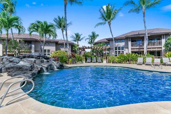 Sparkling resort pool surrounded by tropical gardens