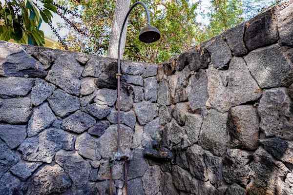 Private Outdoor Rain Shower Enclosed by Custom Natural Stone Walls