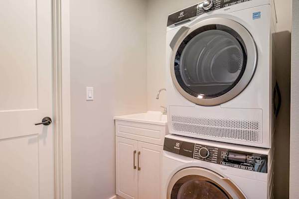 In-Unit Laundry Room with Stacked Washer, Dryer & Utility Sink