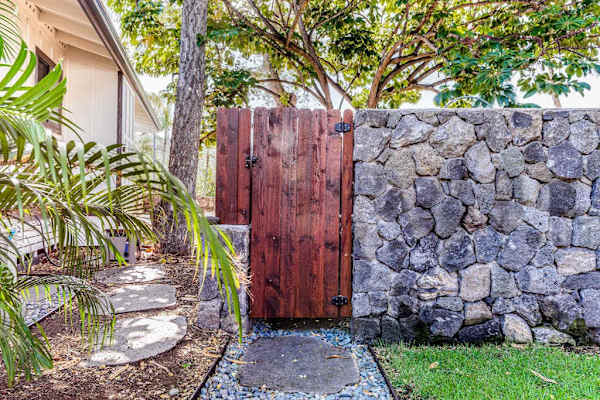 Private Gated Entrance with Custom Stone Wall & Wooden Gate