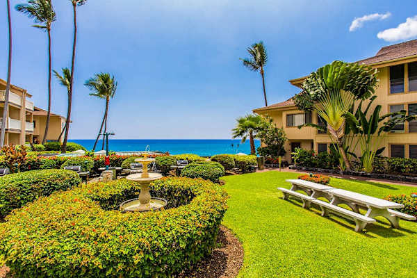 Landscaped Resort Courtyard Featuring Tiered Fountain & Ocean Backdrop