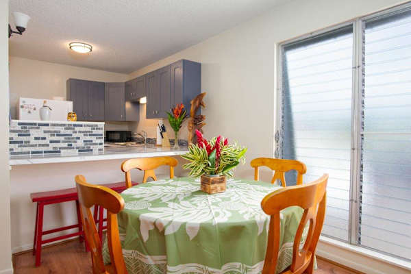 Dining room with seating for four with barstools for extra seating. 