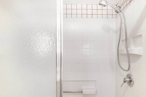 Clean Walk-In Shower / Tub Enclosure with Modern Fixtures