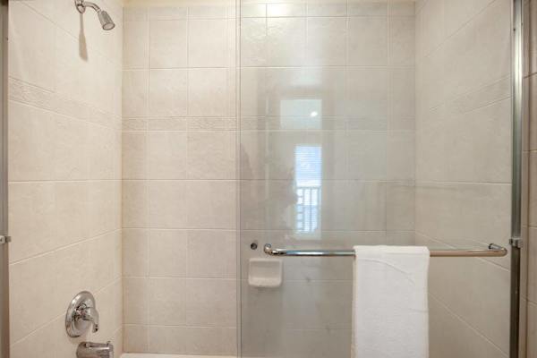 Clean Walk-In Shower with Fresh Bath Linens & Tile Wall Finish