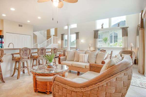 Open-Concept Living Room with Wicker Seating & Kitchen Bar View