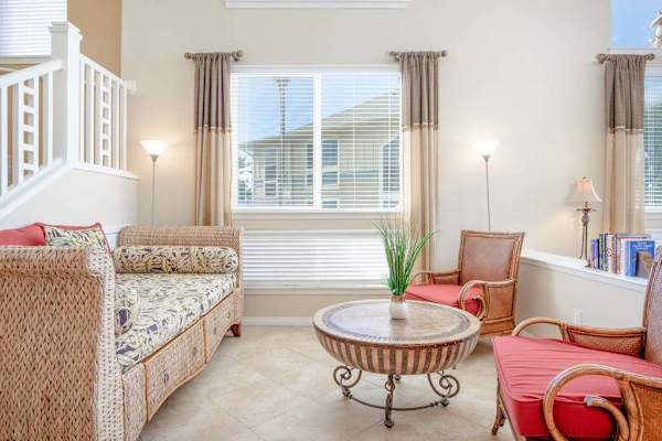 Sunlit Living Room Lounge with Accent Seating & Staircase Access