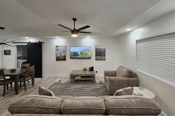 Large living room with a sofa bed and a flat screen tv.  The open concept design allows for you to stay connected to everyone.