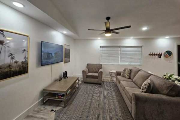 Large living room with a sofa bed and a flat screen tv.  The open concept design allows for you to stay connected to everyone.