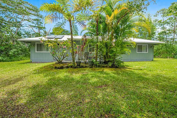 Escape to a private tropical backyard oasis surrounded by lush Hawaiian landscaping, swaying palms, and the peaceful beauty of paradise.