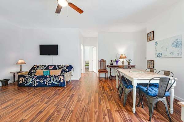 Large living room with a sofa bed and a flat screen tv.