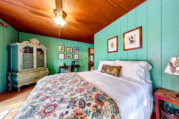 Master bedroom with king bed with and wall to ceiling feelings. 