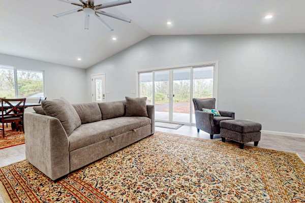 Open concept living with a sofa bed for any extra guests that stop by and a flat screen tv.